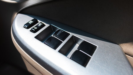 Explore the intricate design of a car's power window control switch showcasing modern automotive technology.の写真素材