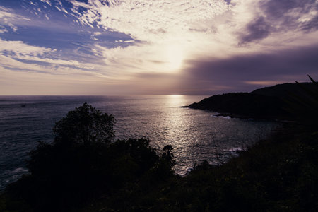 A serene sunset casts a golden hue over the tranquil ocean inviting reflection and peace.の写真素材