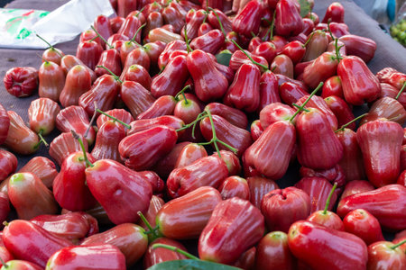Explore a bustling market scene filled with vibrant red fruits showcasing nature's bounty.の写真素材