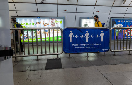 London. UK. 10.09.2020. A passenger information banner in a London Underground station reminding passengers to keep a safe distance during Covid-19 pandemic.のeditorial素材