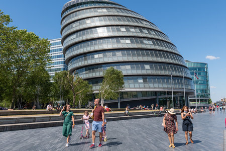 London.UK.06.09.2020. Exterior view of the capital's City Hall situated by the South Bank with people walking by.のeditorial素材