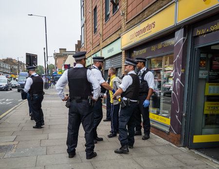 London.UK.11.03.2020. Police officers making an arrest of a man on the high street of the East End...