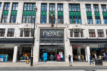 London.UK.06.20.2020. The flagship store of the British fashion chain Next on Oxford Street showing the company name sign and shop frontage.のeditorial素材