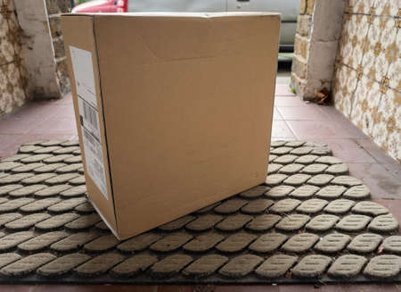 A parcel delivered to the front door without contact between the customer and the delivery person. A safety measure during Covid-19 pandemic.の写真素材