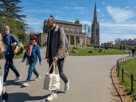 London. UK. 04.18.2021. People out socialising and enjoying a warm sunny Spring day in a park.