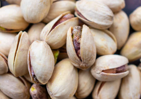 Closeup of a pile of dry salted pistachios.の写真素材