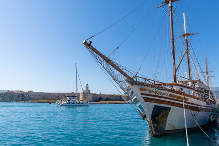 Lefkada island. Greece- 08.06.2021: an old wooden sailing ship moored by Agia Mavra Castle.のeditorial素材