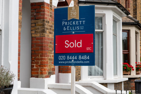 London. UK. 10.03.2021. A property sold sign outside a suburban terrace house with property prices raising dramatically in the countryside.のeditorial素材