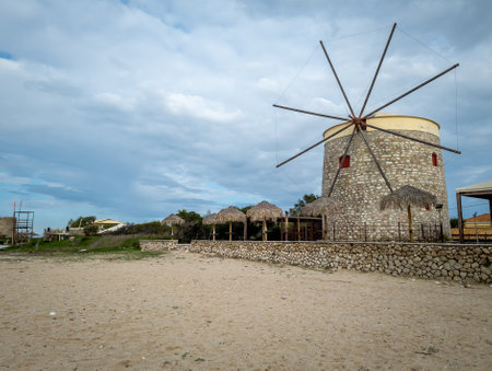 Lefkada. Greece- 10.26.2021. A restored stoned wind mill on the island. Part of a restaurant, bar catering for tourists.のeditorial素材