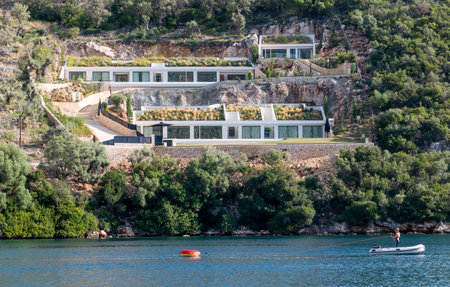 Lefkada. Greece-10.20.2021. A modern architectural villa design development on the hill side seafront of Syvota. A busy sailing holiday resort.のeditorial素材
