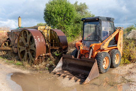 Old construction heavy machinery on a building site.のeditorial素材