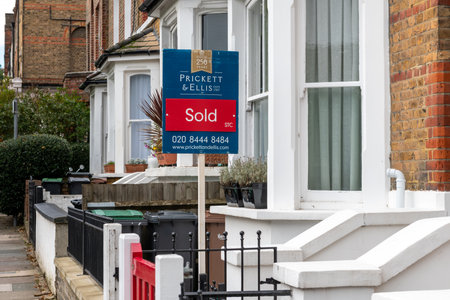 London. UK. 10.03.2021. A property sold sign outside a suburban terrace house with property prices raising dramatically in the countryside.のeditorial素材