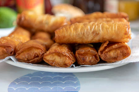 A full plate of fried golden, crispy spring rolls.の写真素材