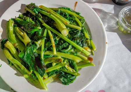 A random plate of fresh Chinese vegetable Kai Lan served with a sprinkle of sesame oil and oyster sauce.の写真素材