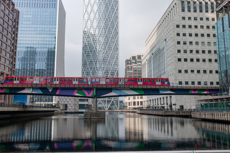 London. UK-03.30.2022. A general of Middle Dock in Canary Wharf with the Docklands Light Railway and skyscrapers.のeditorial素材