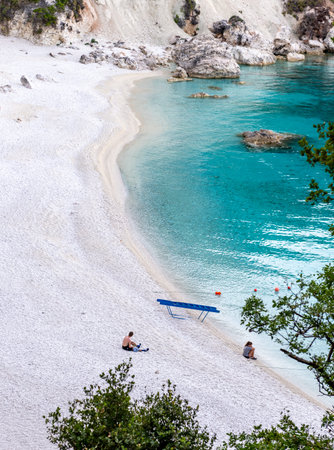 Lefkada Island, Greece-06.05.2022. Young tourists visiting Agiofili Beach early morning before it get crowded.のeditorial素材
