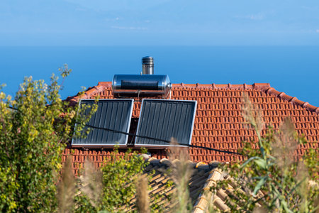 Domestic solar panels on a roof top for hot water heating.