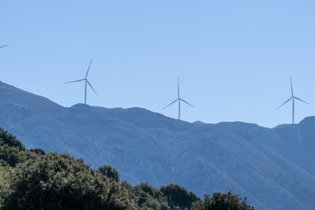 A distance view of wind turbines on a mountain top.の写真素材