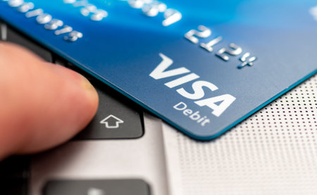 London. UK- 01.29.2023. A Visa Debit card on a laptop computer with a person pressing the enter...