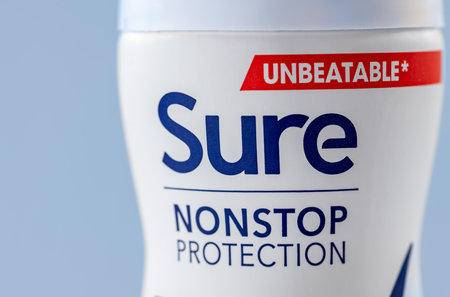 London. UK- 03.01.2023. Close up of Sure deodorant spray isolated with a blue background.のeditorial素材