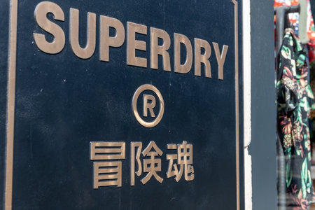 London. UK- 04.09.2023. The facade of the Superdry retail store on Oxford Street showing the company  name sign and logo.のeditorial素材