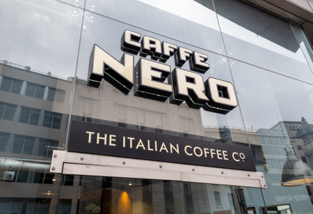 London. UK- 04.15.2023. The name sign and facade of a branch of Caffe Nero.のeditorial素材
