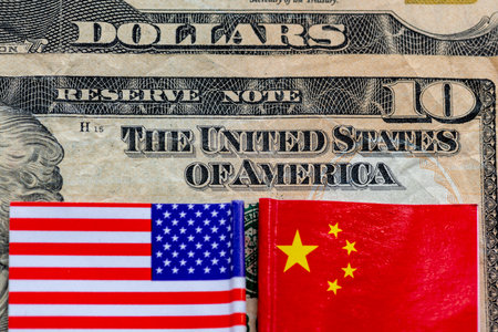 A ten US Dollars bill with American and Chinese flags. Trade, currency war concept.の写真素材