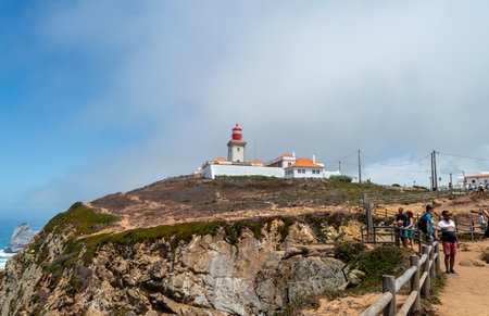 Cape Roca. Portugal- 07.08.2023. A distant view of the Cape Roca Lighthouse or Cabo da Roca Lighthouse.のeditorial素材
