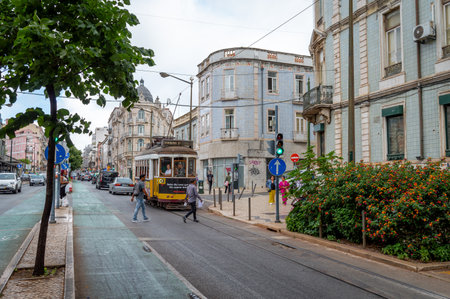 Lisbon. Portugal- 07.08.2023. A street view of a tram car carrying passenger on the street  of the capital popular with tourists.のeditorial素材