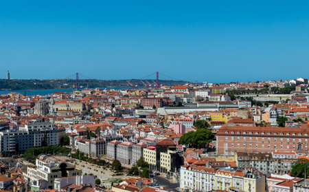 Lisbon. Portugal- 07.09.2023. Panoramic view of the capital from Alfama with a view of the 25th April Bridge.のeditorial素材