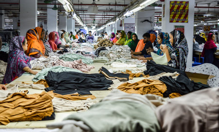 Narayanganj. Bangladesh- 08.23.2023. Interior of a knitwear factory with staffs working in the...