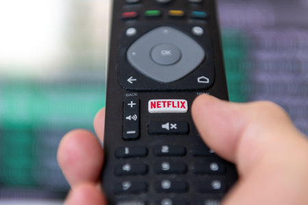 London. UK- 09.13.2023. A person using the remote control to access the popular streaming entertainment service provider Netflix.のeditorial素材