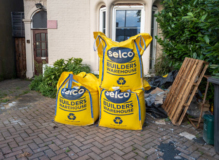 London. UK- 09.02.2023. Large sacks of building material delivered outside the front yard of a house...