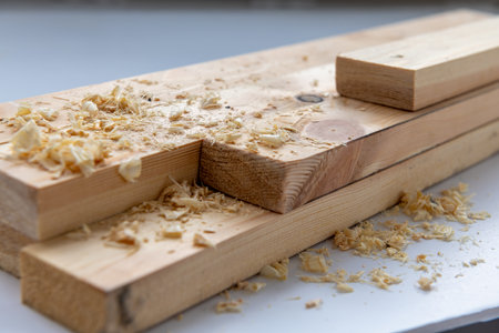 Close up of ready prepared pine wood timber with some wood shavings.