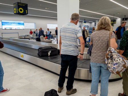 Aktion airport.Greece- 10.04.2023. Arriving passengers waiting to pick up their luggages.のeditorial素材