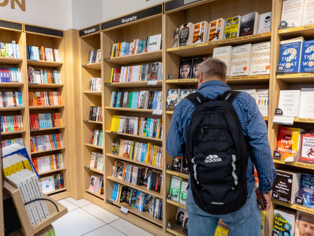 Gatwick airport. UK- 10.04.2023. People in a branch of WH Smith looking to buy paper books for their travel.のeditorial素材