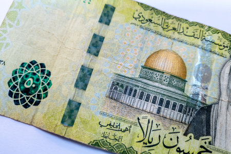 Close up of a fifty riyals Saudi bank note isolated in white.