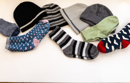 Various woolly hats and thick Winter socks isolated in a white background.の写真素材