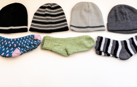 Different pattern woolly hats and thick Winter socks isolated in a white background.の写真素材