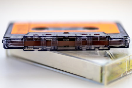 Close up of a old music cassette tape and its holder isolated in white.の写真素材