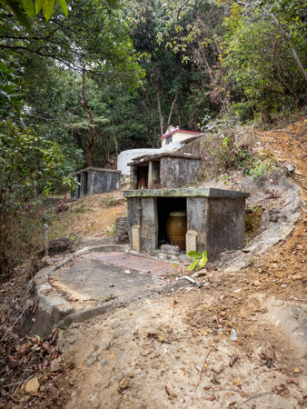 Chinese traditional graves on a hillside in a rural area of Hong Kong New Territories.の写真素材
