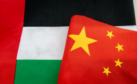 A close up of the United Arab Emirates national flag next to the Chinese national flag. A UAE, China relations concept.の写真素材