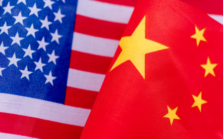 A close up of the USA national flag next to the Chinese national flag. A USA, China relations concept.の写真素材