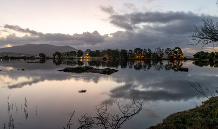 A predawn view of a wetland wildlife habitat, salt marsh, with beautiful light and reflections on the still water.の写真素材