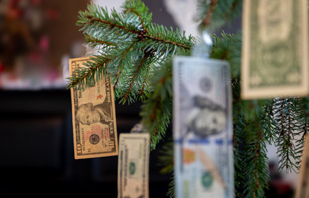 A close up living room view of various US Dollar bills hanging in a Christmas tree as decorations. A US Christmas expenses, cost of Christmas concept.の写真素材