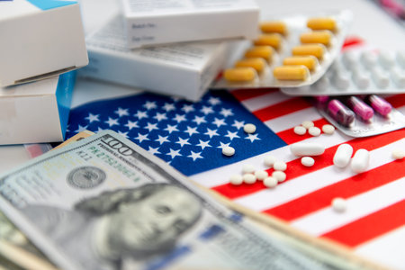 An American medical health cost concept with a stack of dollar bills and packages of medicine on the flag of America.の写真素材