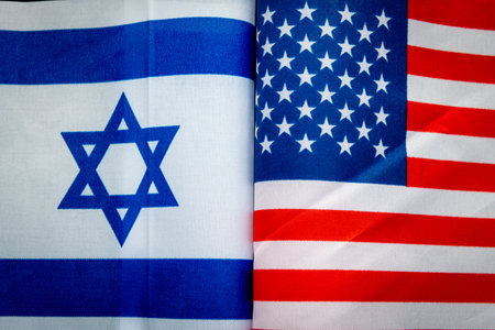 A close up of the national flag of Israel and the United States of America. An American, Israeli...
