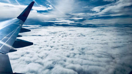 airplane in the cloudy skyの写真素材