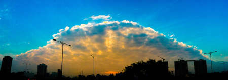 sunset over the city, look like UFO in the sky