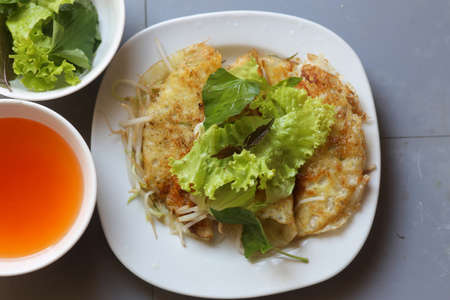 Close-up of crispy Vietnamese pancake with vegetable and fish sauceの写真素材